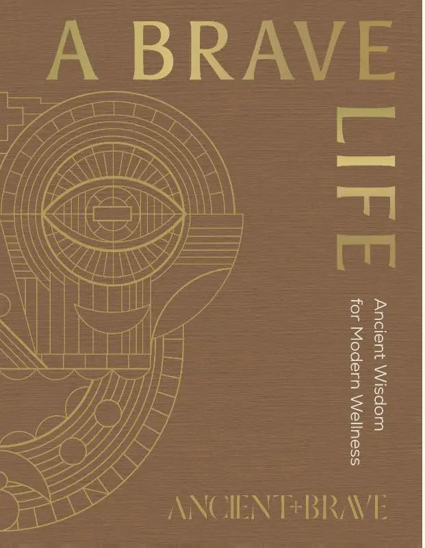 Boek A Brave Life met bruin kaft, goudfolie letters en geometrisch oogontwerp voor persoonlijke ontwikkeling