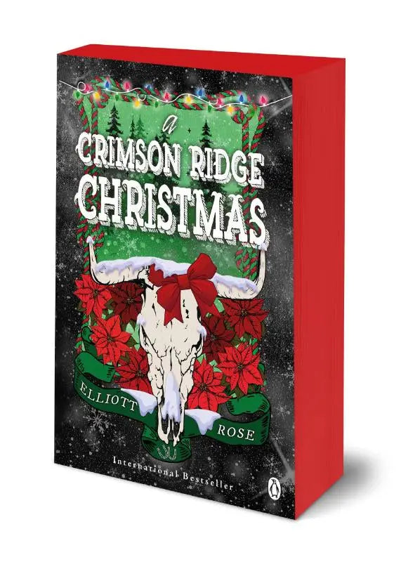 A hardcover boek crimson ridge christmas van elliott rose met een witte stierschedel en kerstdecoraties, intense romantische fictie in de outback