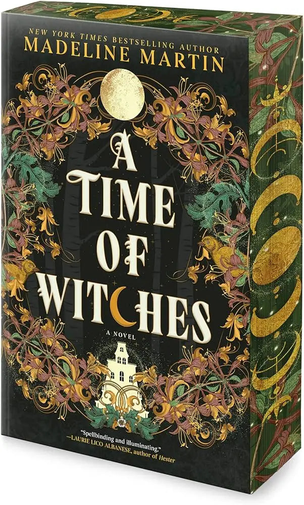A hardcover book titled a time of witches by madeline martin with dark green cover and ornate gold floral designs