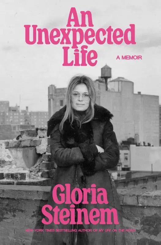 Pink text on a black-and-white cover of the memoir an unexpected life by gloria steinem published by ebury press