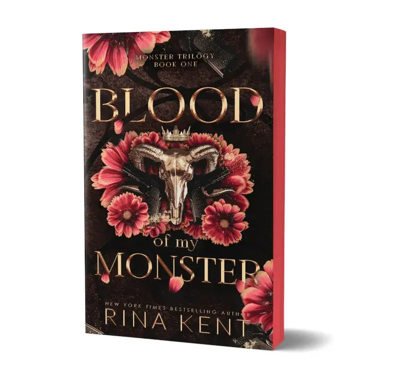 Deluxe edition paperback blood of my monster met gouden letters en een met bloemen omgeven ram schedel op de donkere omslag