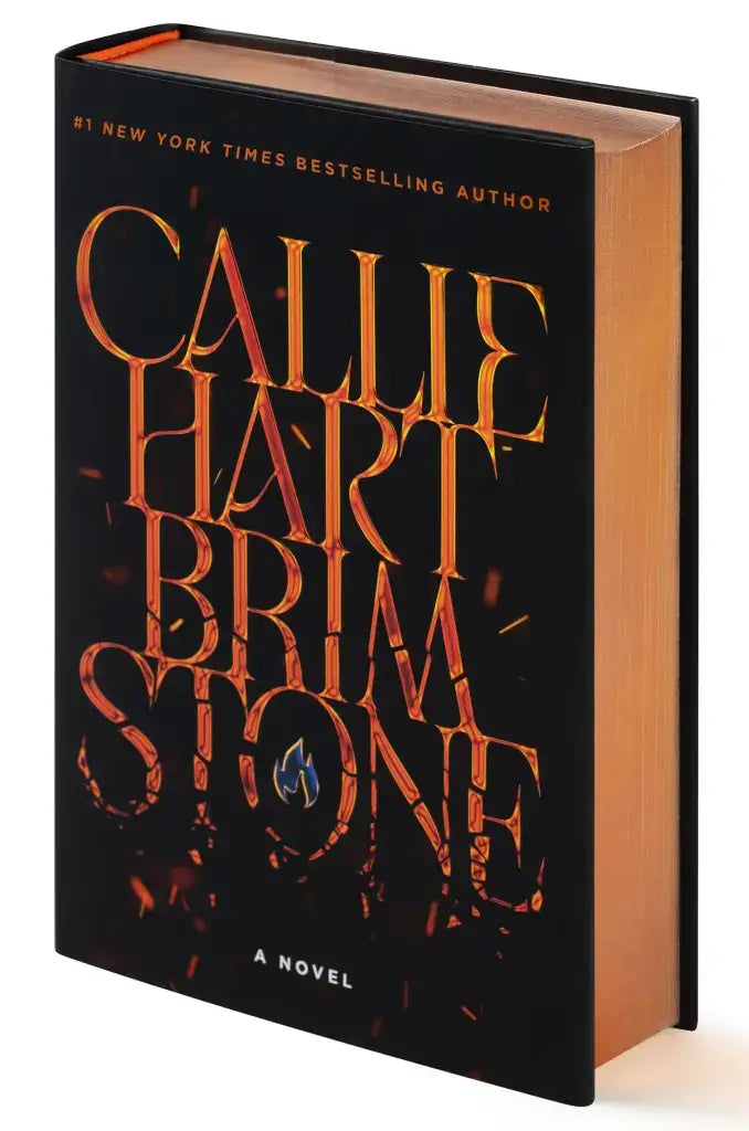 Zwarte deluxe limited hardback van callie hart bodemsteen met goud-oranje letters en vlamachtig ontwerp op kaft