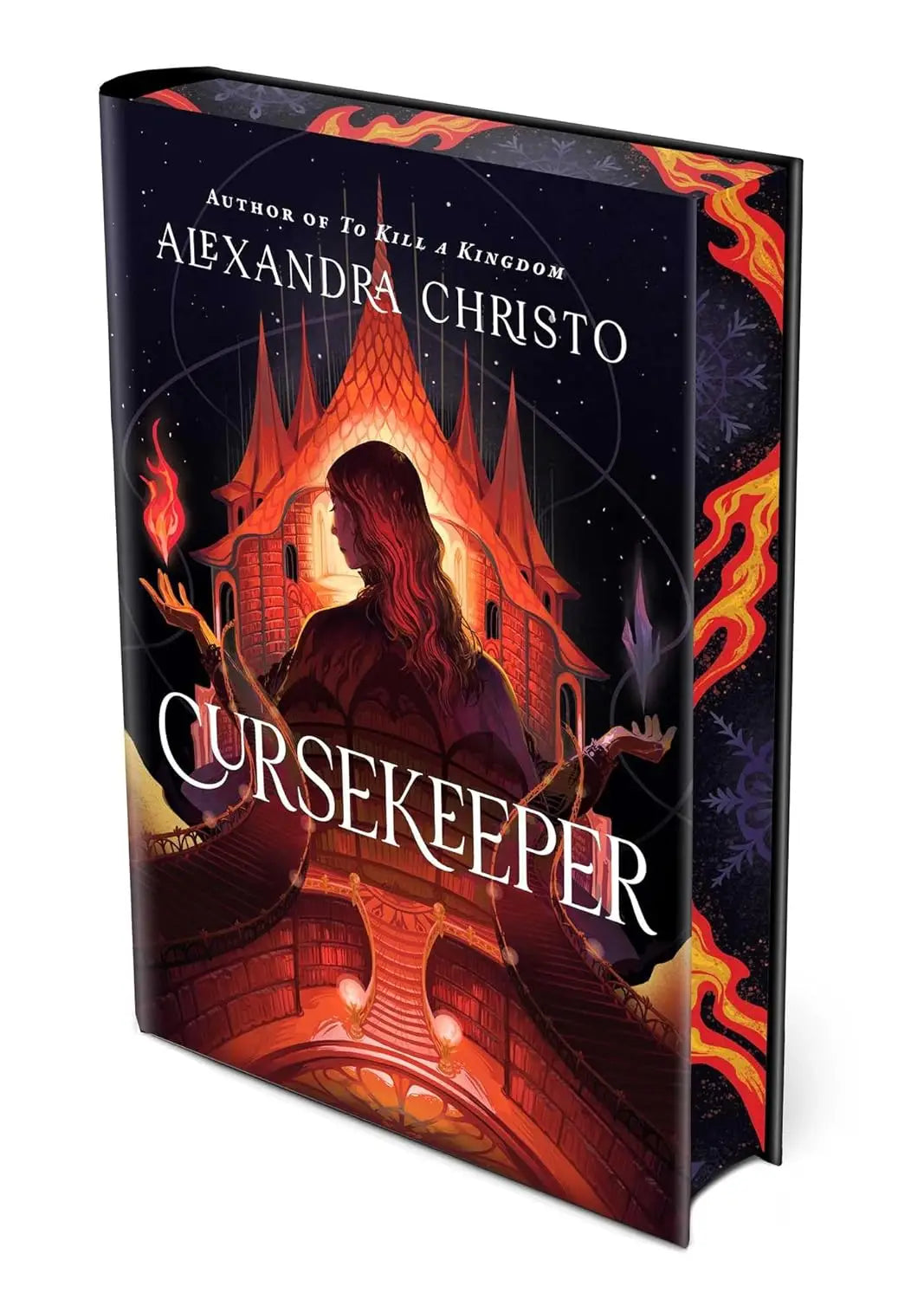 Hardcover boek cursekeeper deluxe edition van alexandra christo met donkeromslag en vurige vlammen rondom silhouet vrouw en kasteel