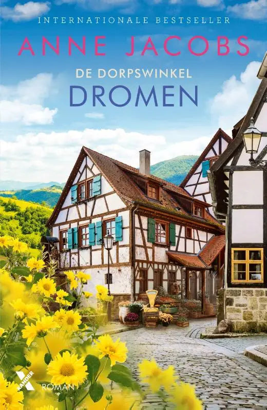 De cover van het boek Dromen toont traditionele vakwerkhuizen met witte muren en donkere balken tegen groene heuvels