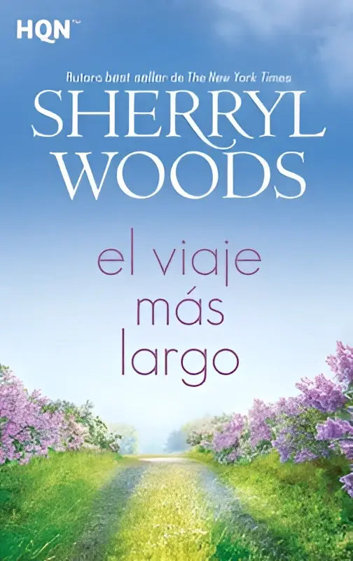 De boekcover van el viaje más largo door sherryl woods toont een kronkelend pad met paarse bloesembomen onder een blauwe hemel