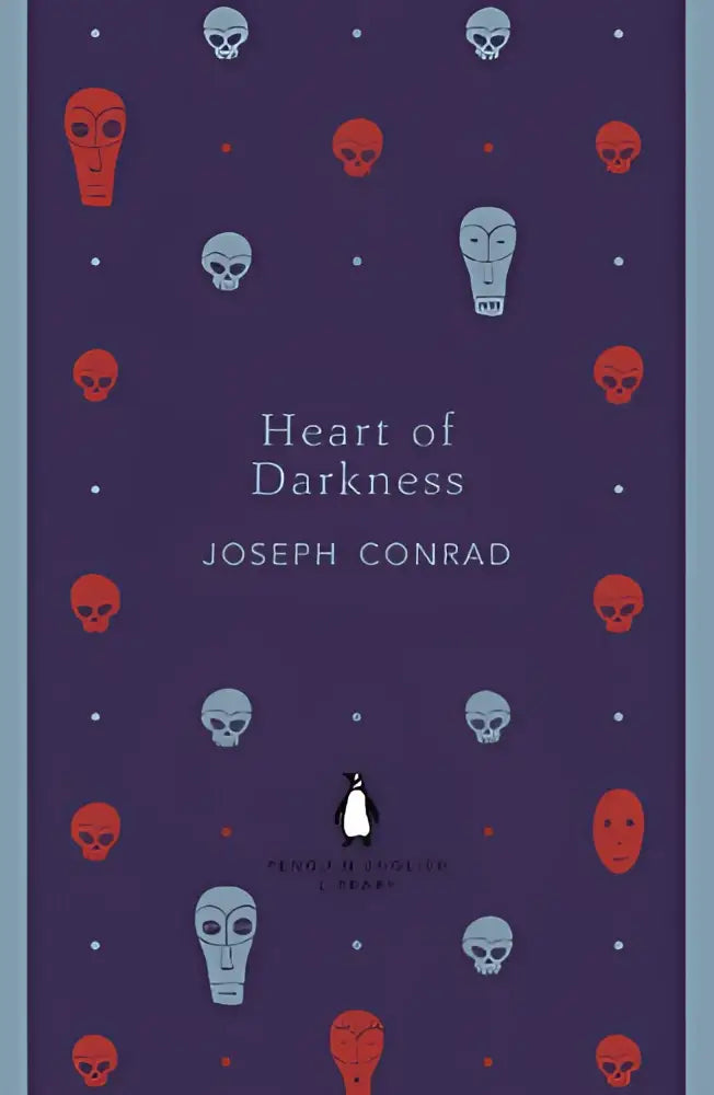Donkerpaarse boekomslag met roodblauw schedelpatroon en witte titel heart of darkness van joseph conrad in the penguin english library