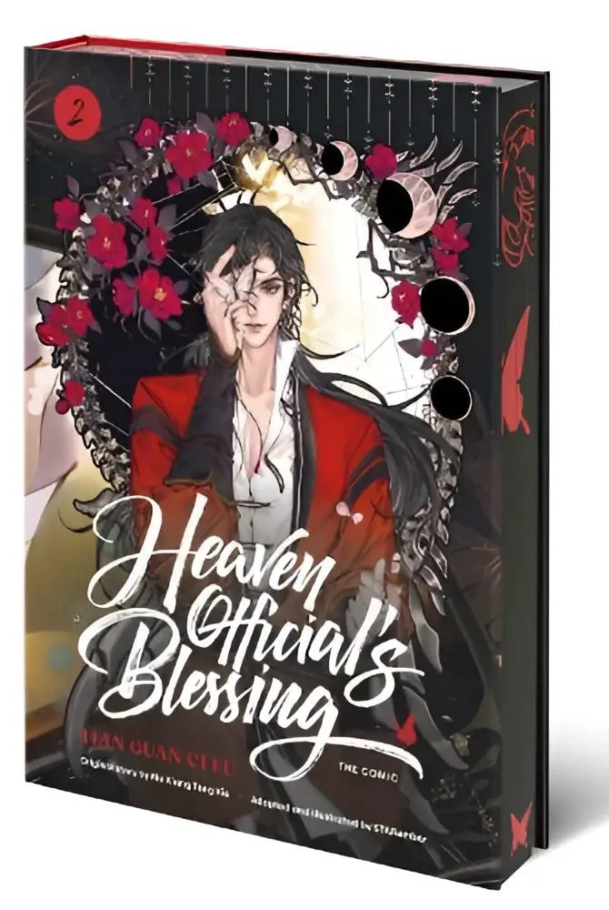 Hardcover edition of heaven official’s blessing the comic volume 2 featuring red and black floral designs and moon phases