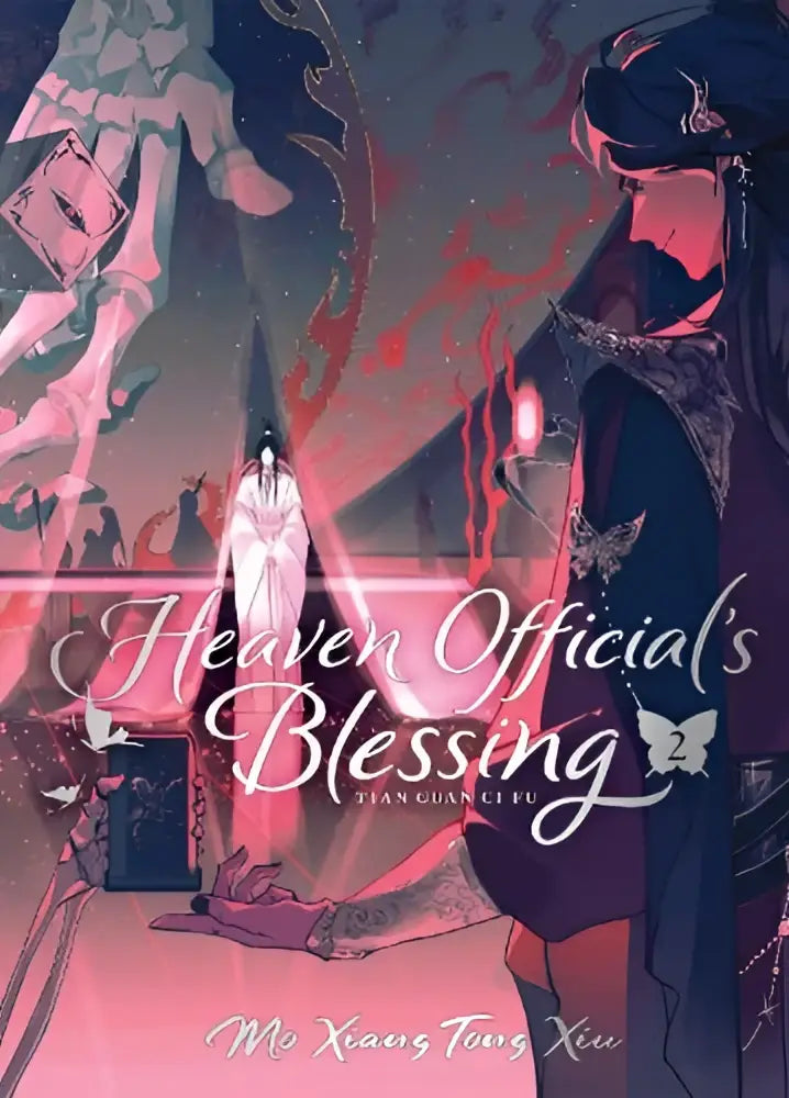 Cover van heaven official’s blessing deluxe hardcover novel vol 2 met figuur in wit gewaad bij altaar en rode vlinders