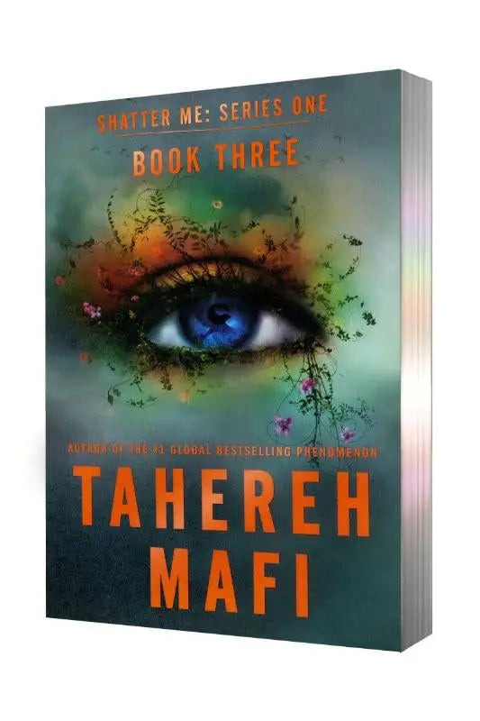 De paperback deluxe limited edition van ignite me toont een blauwe oog en kleurrijke bloemen op een teal achtergrond