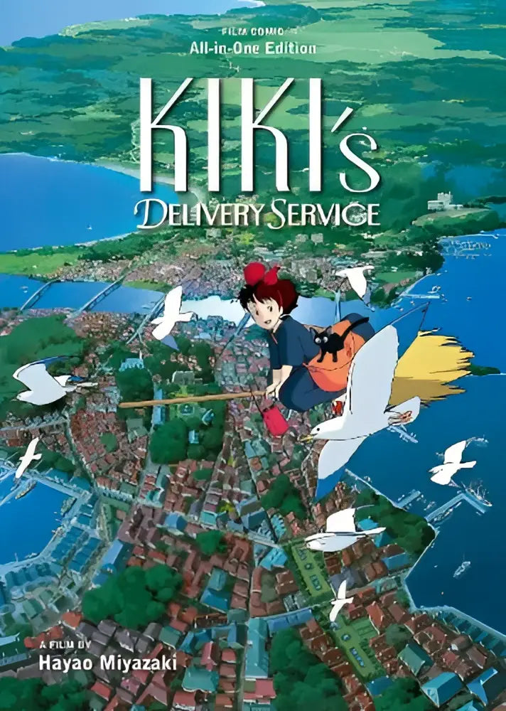 Cover van kiki’s delivery service film comic all-in-one edition met kiki vliegend op een bezem boven een kuststad en witte vogels