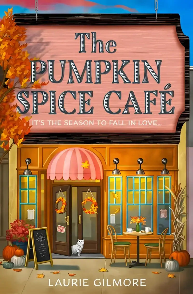De pumpkin spice café boekomslag toont een warme herfstsfeer met oranje pompoenen en gezellige interieurdetails