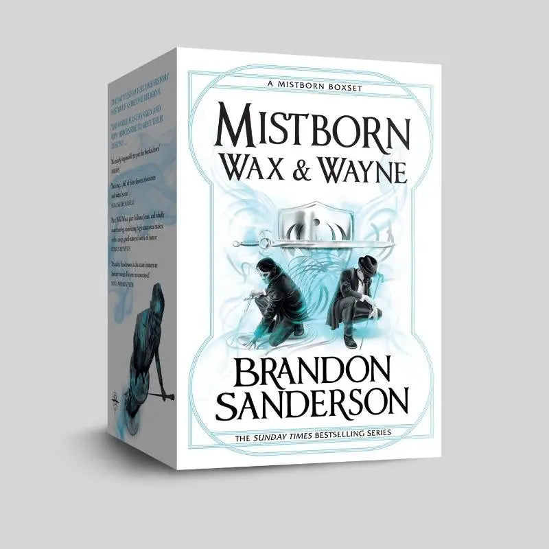Witte kartonnen doos met mistborn wax en wayne the complete series van brandon sanderson met illustratie van twee figuren en een zilveren zwaard tegen een lichtblauwe mistige achtergrond voor the alloy