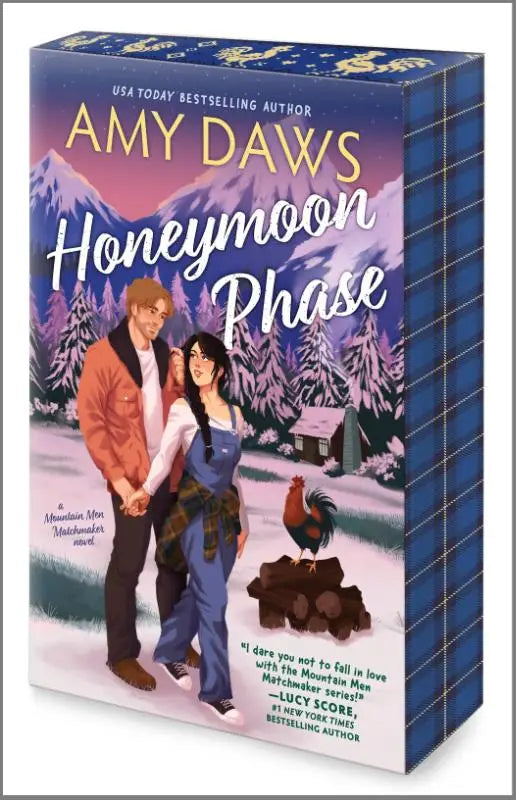 De boekbox honeymoon phase van amy daws toont een levendige illustratie van een paar in winterkleding tegen besneeuwde bergen in de mountain men matchmaker serie