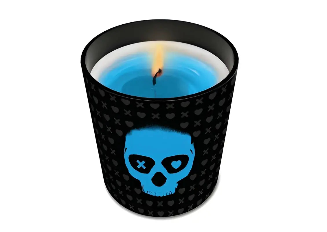 Navessa allen lights out scented candle with black exterior blue skull design and lit vibrant blue wax wick