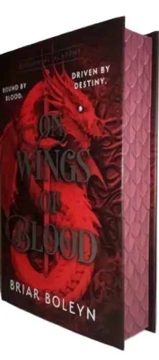 Hardcover editie van on wings of blood door briar boleyn met rode draak en metalen reliëf, bloodwing academy thema
