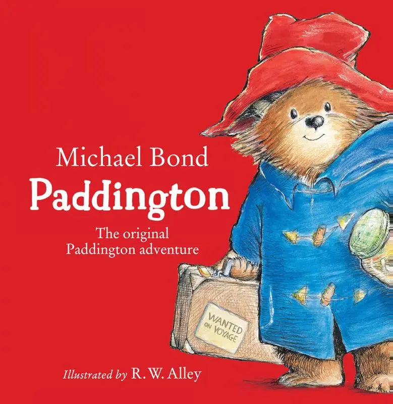 Paddington in blauwe jas met gele knopen en rode hoed houdt koffer wanted on voyage in original paddington adventure