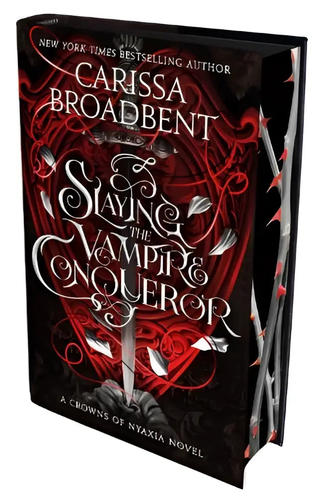 Zwart hardbackboek slaying the vampire conqueror van carissa broadbent met rode en zilveren decoratie en sprayed edge edition