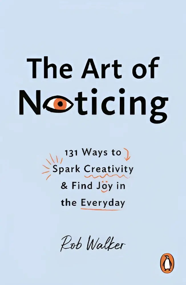 A light blue paperback book titled the art of noticing by rob walker featuring an orange eye graphic published by ebury press