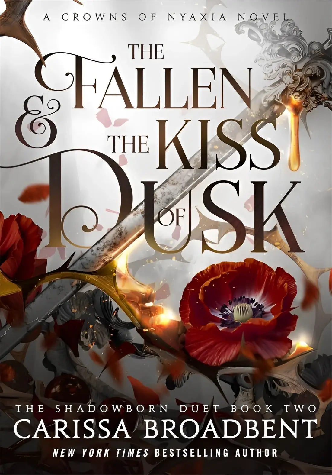 The fallen and the kiss of dusk hardback cover by carissa broadbent features ornate black gold lettering with red poppies skulls and gold elements