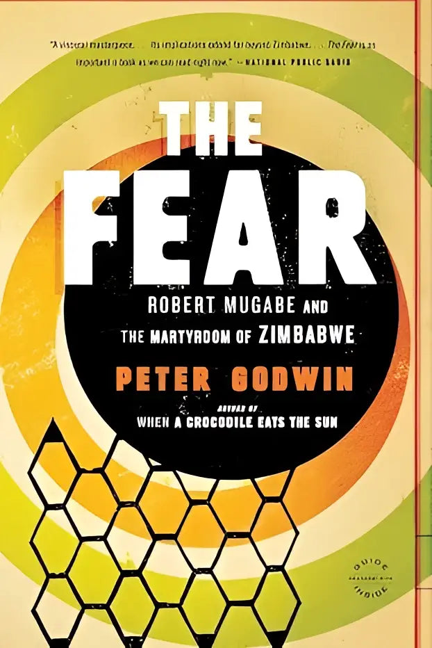The fear hardcover book by peter godwin with bold white lettering on black circle against yellow and green rings