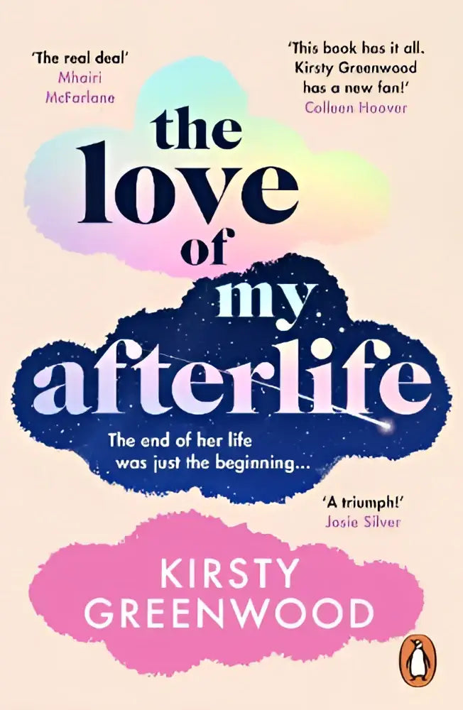 A paperback book titled the love of my afterlife by kirsty greenwood with cloud-shaped navy blue and pink text on pastel cover
