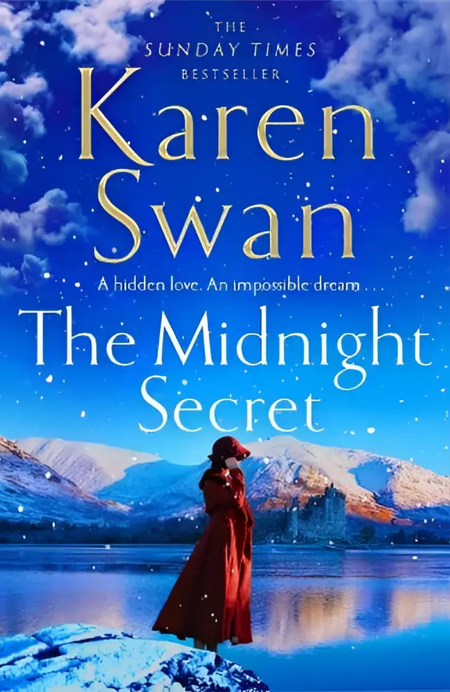 The midnight secret paperback book with a blue cover showing snow-capped mountains and a woman in a red coat