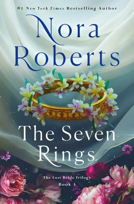 De seven rings door nora roberts toont een boek met een gouden ring versierd met roze en witte bloemen op blauw-lavendel achtergrond