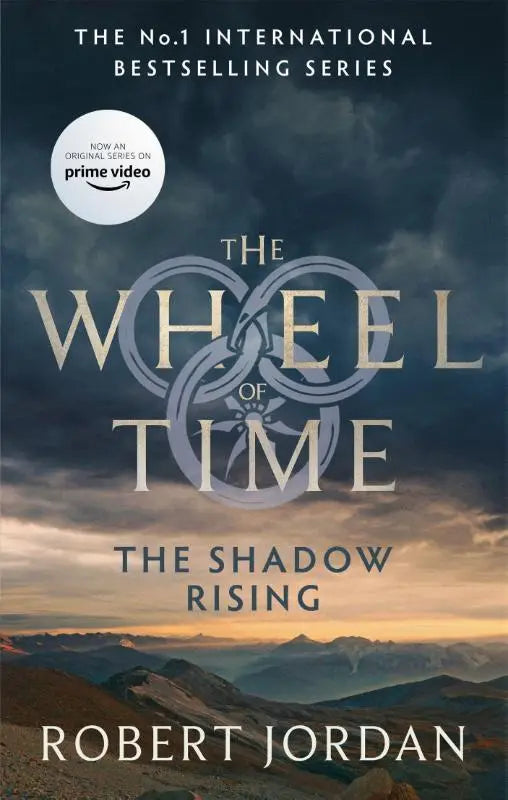 The shadow rising hardcover book with dark clouds and mountains under a golden sky now a major tv series in the wheel