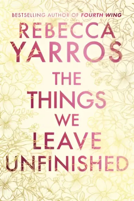 The things we leave unfinished deluxe edition by romance author rebecca yarros features a soft gold and white floral cover