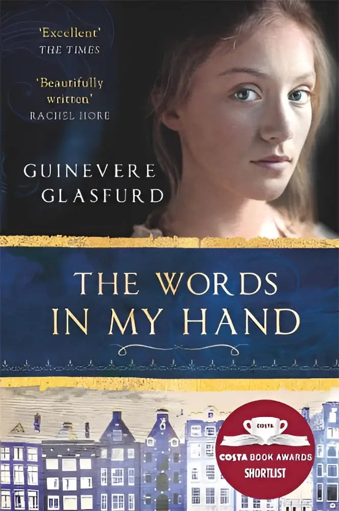The words in my hand by guinevere glasfurd hardcover book with dark blue gold cover showing 17th century amsterdam buildings