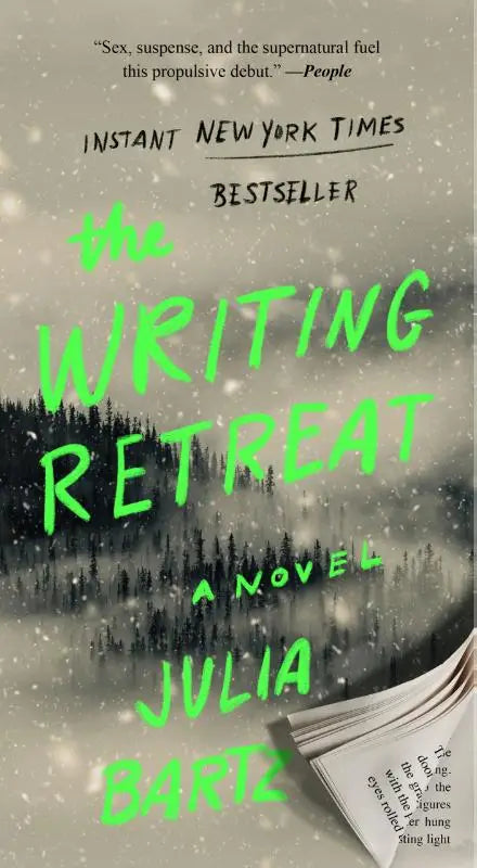 The writing retreat novel by julia bartz features neon green text on a misty forest cover with snowflakes and an open book corner