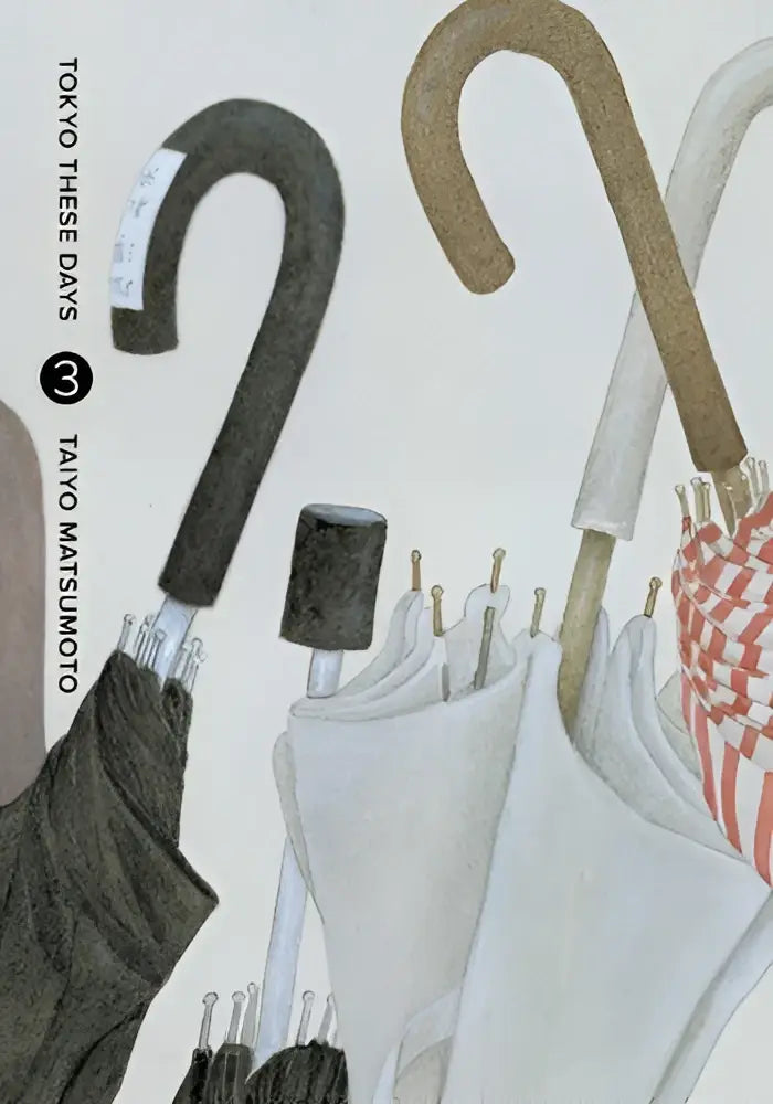 Een collectie elegante gesloten paraplu’s met gebogen handvatten in zwart, bruin en wit met subtiele rood-witte strepen tokyo these days vol 3