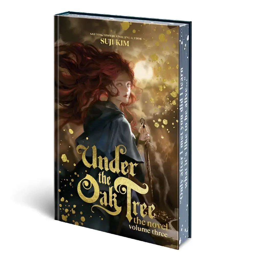 Een hardcover boek van under the oak tree volume 3 met een roodharige vrouw in een donkere mantel en gouden letters