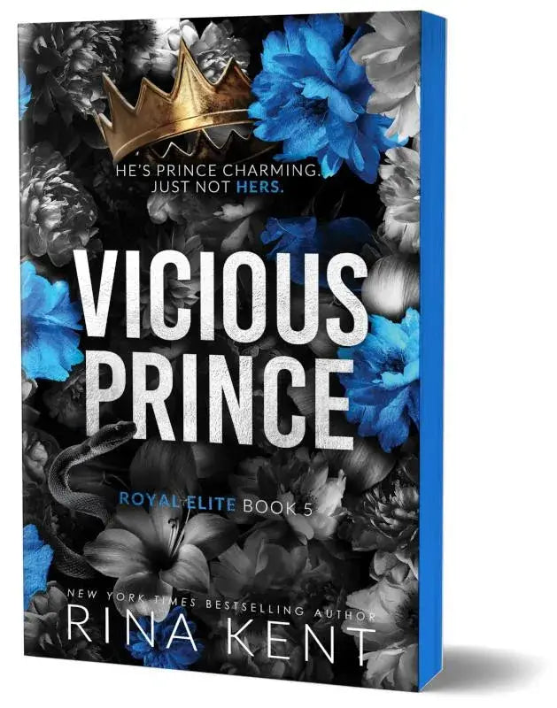 Een hardcover boek vicious prince deluxe edition met een zwart-wit bloemenachtergrond, blauwe bloesems en een gouden kroon