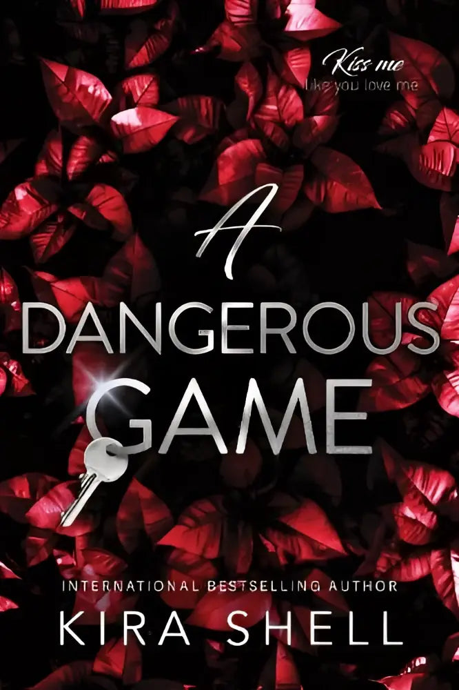 Een zilveren sleutelhanger met metallic glans tegen een achtergrond van diepe rode bladeren en witte tekst in de dark college roman sequel to let the game begin