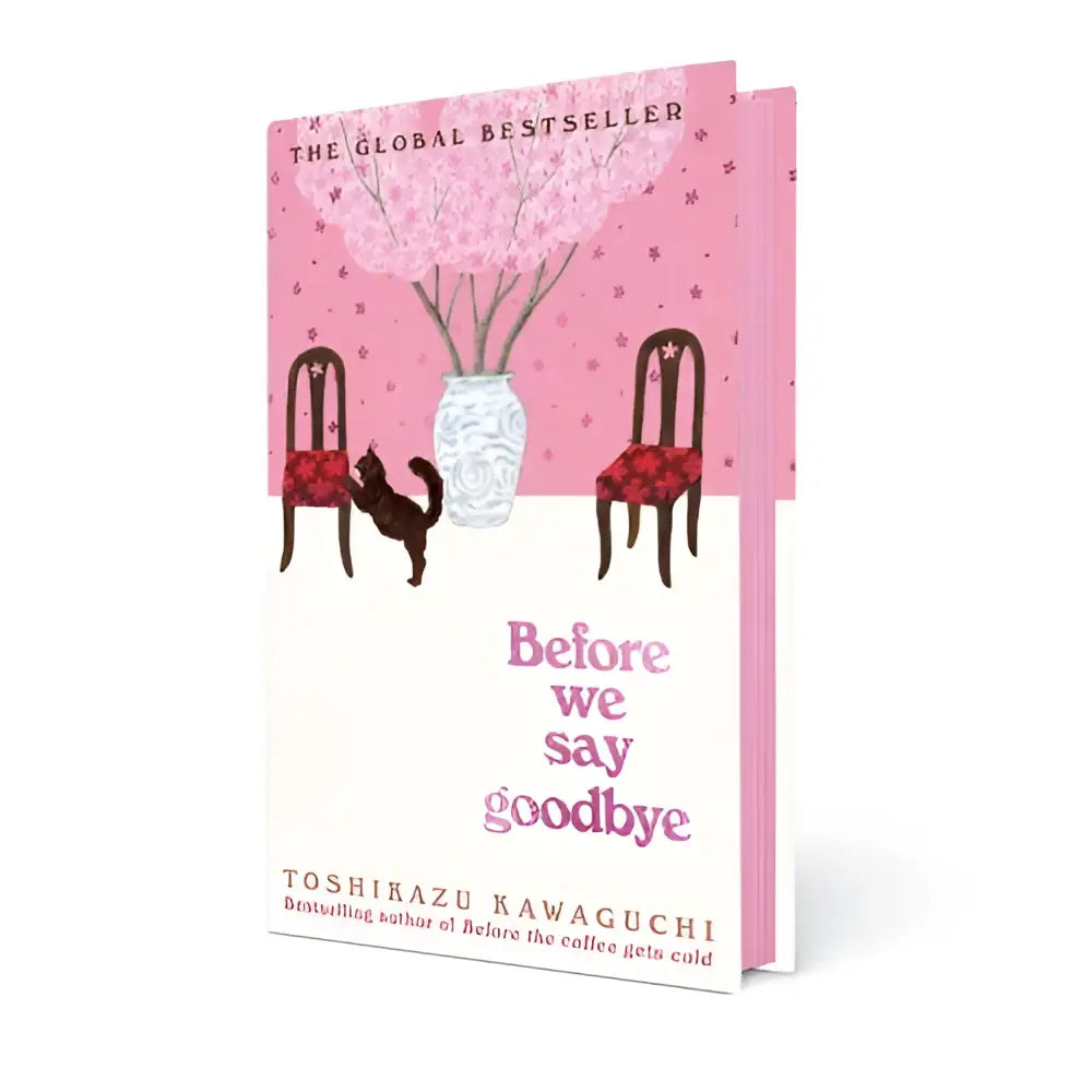 Pink en wit hardcover boek before we say goodbye met bloemenillustratie op de omslag
