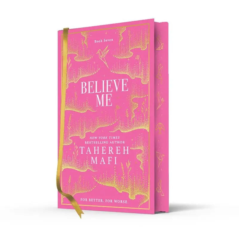 Een levendig roze hardcover boek met goudfolie details en lintmarkering getiteld believe me door tahereh mafi