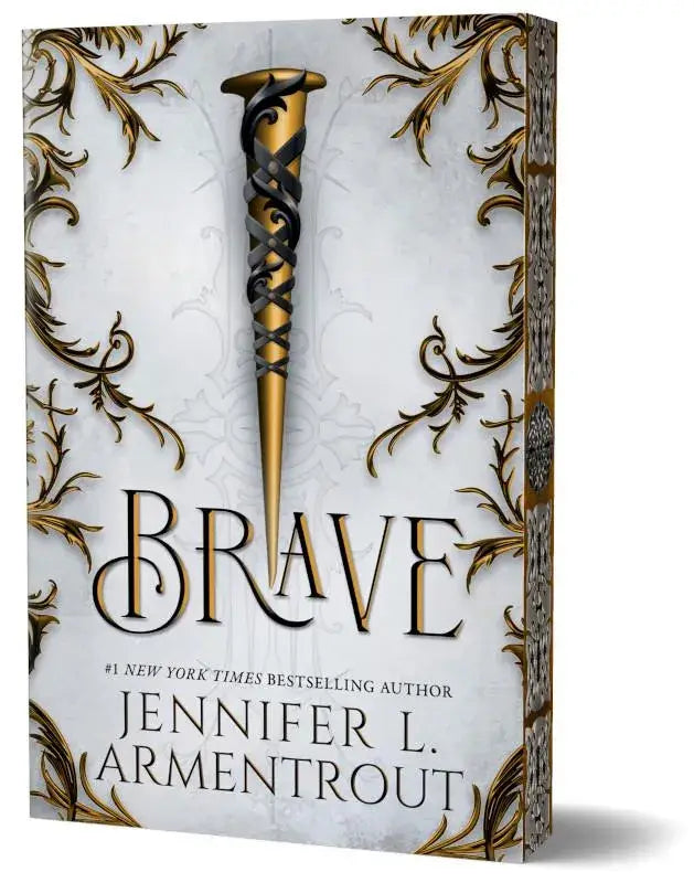 Deluxe editie van brave met goud en zwart ornate nagel en kanten wikkel op boekomslag