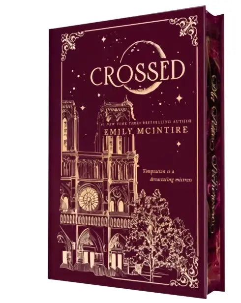 Maroon hardcover book collector’s edition of crossed by emily mcintire with gold foil detailing and notre dame illustration