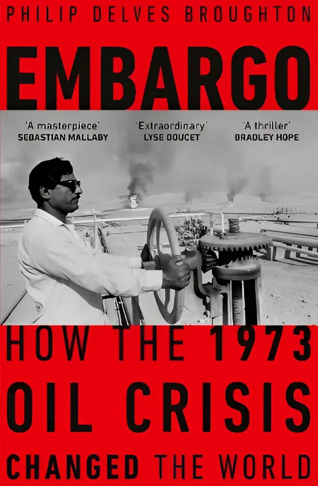 Black-and-white photograph of philip delves broughton gripping an oil valve on an industrial rig for embargo product