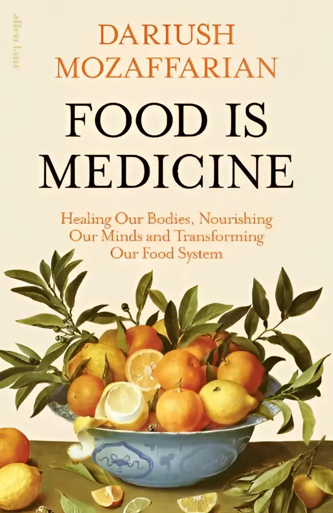 The book cover of food is medicine by dariush mozaffarian shows a blue ceramic bowl with fresh oranges and lemons on beige background