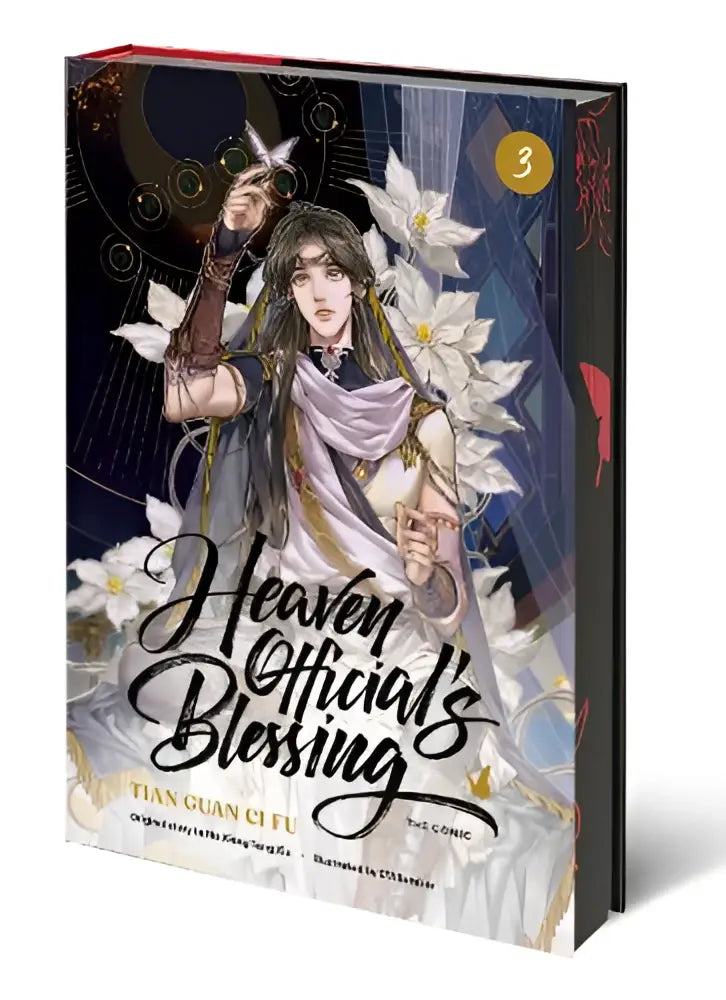 De derde volume van heaven officials blessing comicboek met een personage in vloeiende gewaden en witte bloemen op een donkere achtergrond