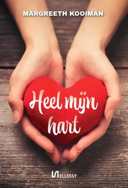 A plush red heart pillow with white cursive text heel mijn hart held gently in two hands