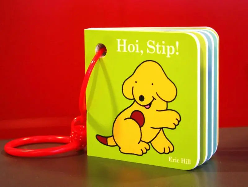 Hallo stip bright green children’s board book with cheerful yellow puppy illustration and red plastic keychain attached