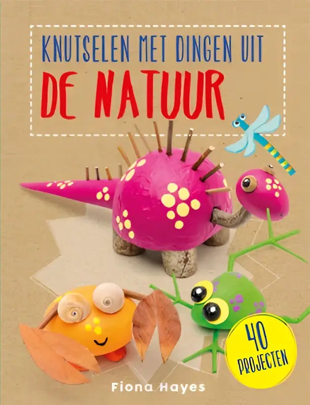 Roze dinosaurusvormige knutsel gemaakt van natuurlijke materialen met witte stippen en bruine stekels met stapsgewijze instructies