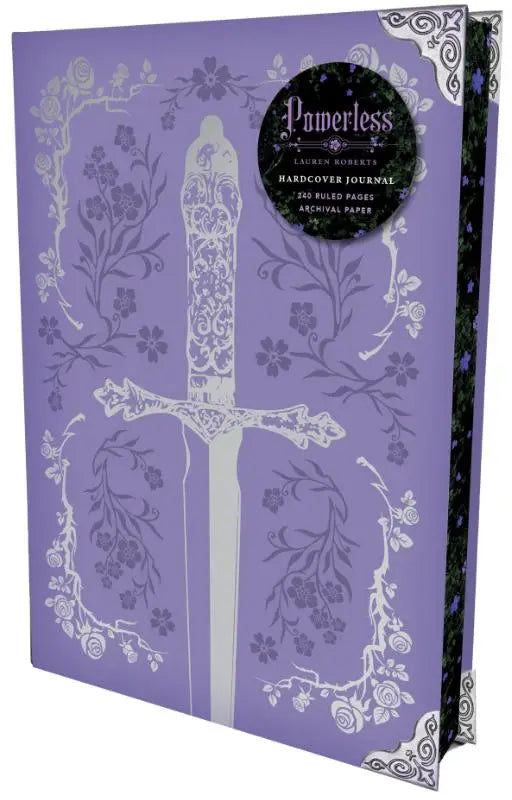 Paars hardcover powerless journal door lauren roberts met wit sierlijk zwaard en bloemmotieven
