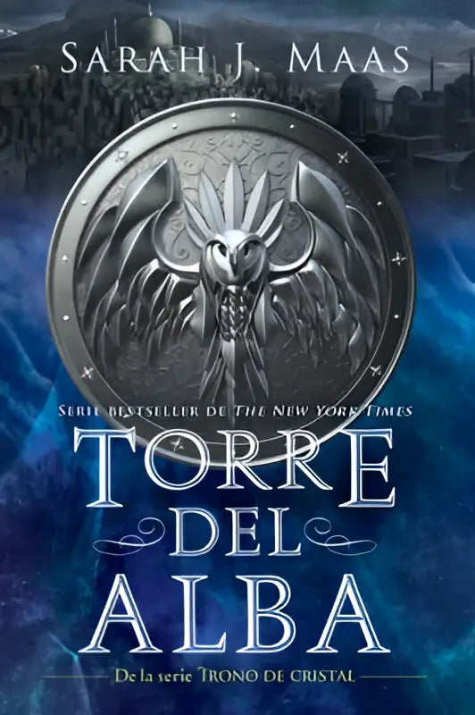 Zilverkleurig metalen embleem met gedetailleerd gevleugeld draakhoofd op de boekomslag van torre del alba