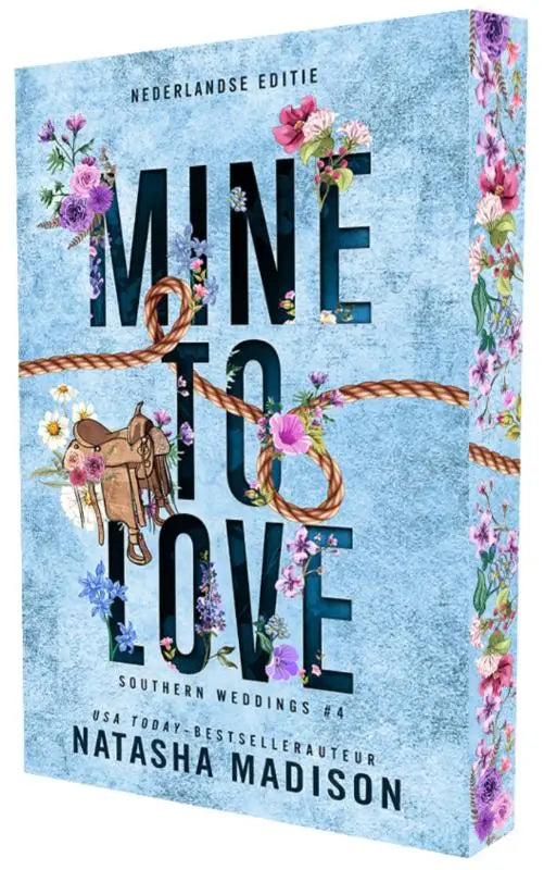 Een zachtblauw boek met de titel mine to love door natasha madison, versierd met bloemen en een door touw gebonden zadel, geschikt voor southern weddings