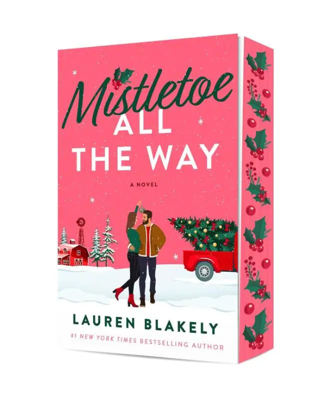 Roze harde kaft boek mistletoe all the way van lauren blakely met feestelijke omslag en dansend paar voor rode kersttruck