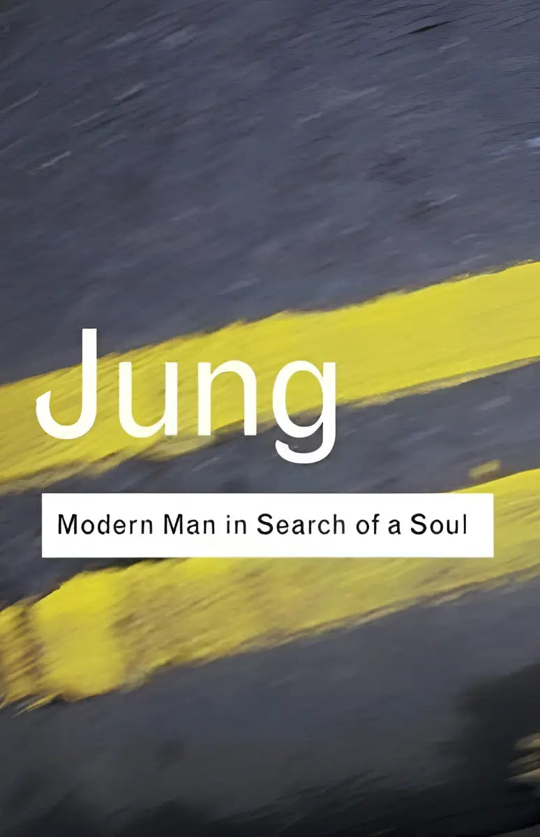 De boekomslag van modern man in search of a soul toont de titel jung in witte letters op een donkere asfaltachtergrond met gele strepen